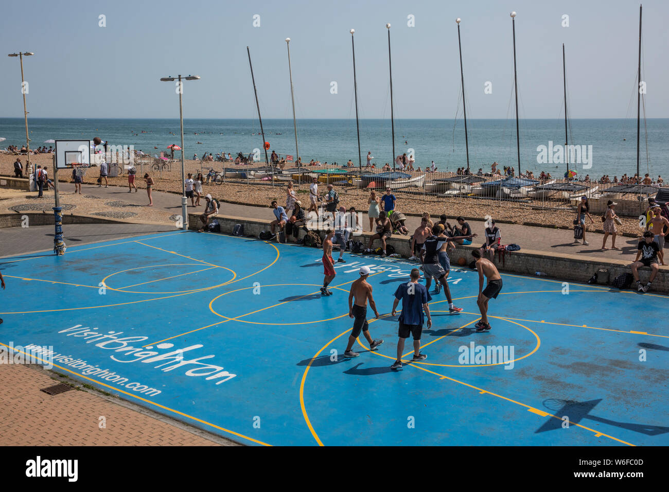 Basketball players enjoy the sunshine on Brighton Seafront, seaside town in the county of East Sussex, England, United Kingdom Stock Photo