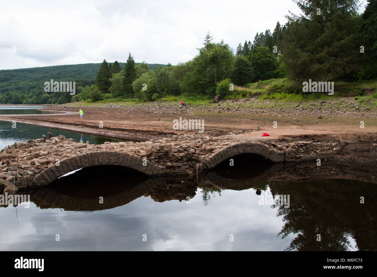 Llwyn On Reservoir, South Wales, UK. 1st Aug, 2019. UK weather: With the continued heatwave over recent weeks, the reservoir has depleted and uncovered an old bridge normally underwater, Pont Yr Daf. It was in use before the reservoir's construction. Credit: Andrew Bartlett/Alamy Live News Stock Photo
