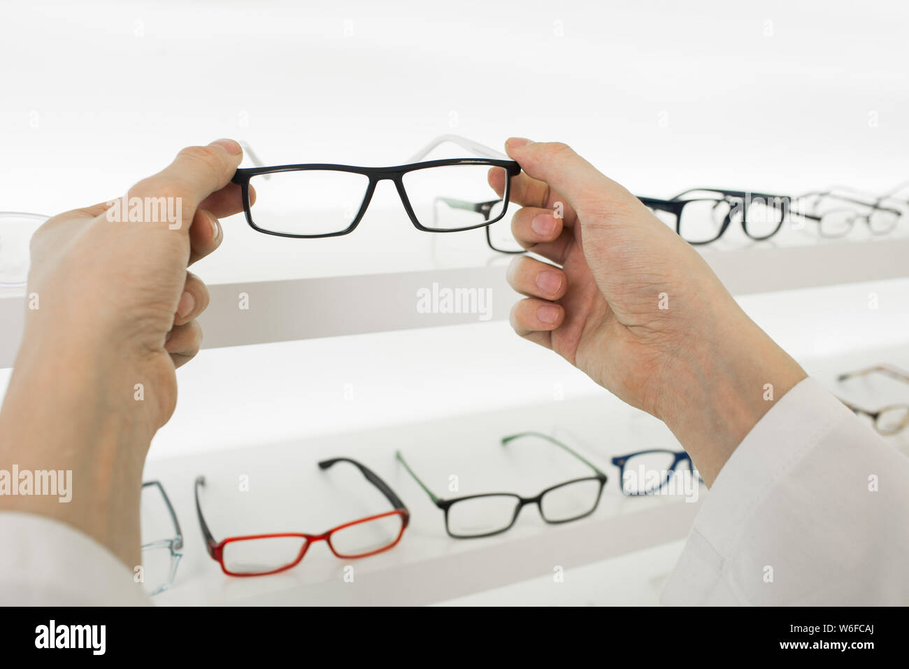 doctor's hands and glasses, close-up Stock Photo