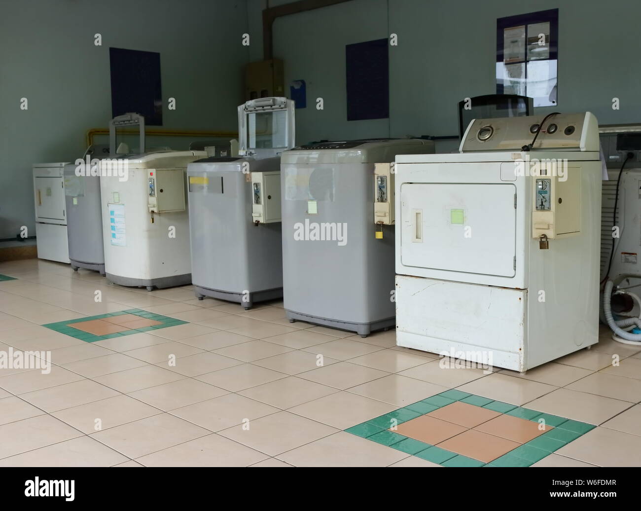 Close-up of coin-operated laundromats installed in a residential building Stock Photo