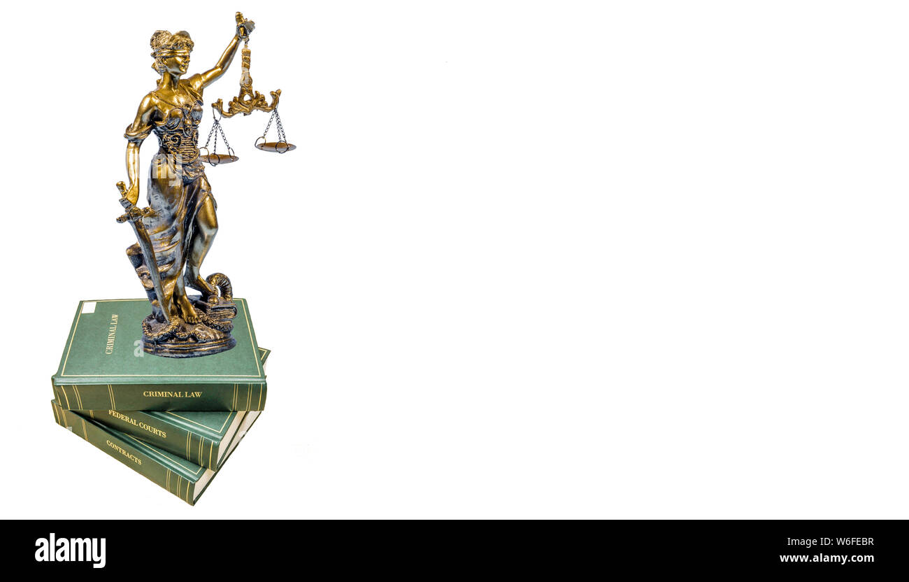 Statue of the goddess of justice on the law books on a white background Stock Photo
