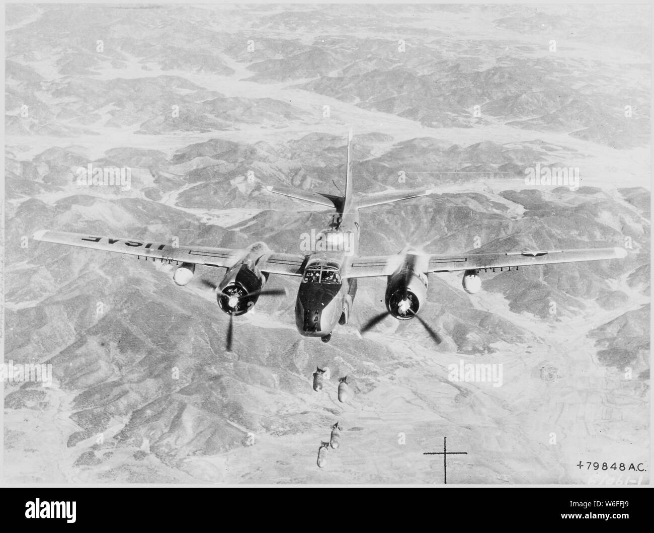 Bombs Away-This Fifth Air Force B-26 Invader of the 452nd Bombardment Wing drops its load of general purpose bombs on a vital Communist target in North Korea. Continued interdiction bombing of enemy supply centers, troop concentrations and communication lines is depriving the Communist troops of sorely needed war supplies. Stock Photo