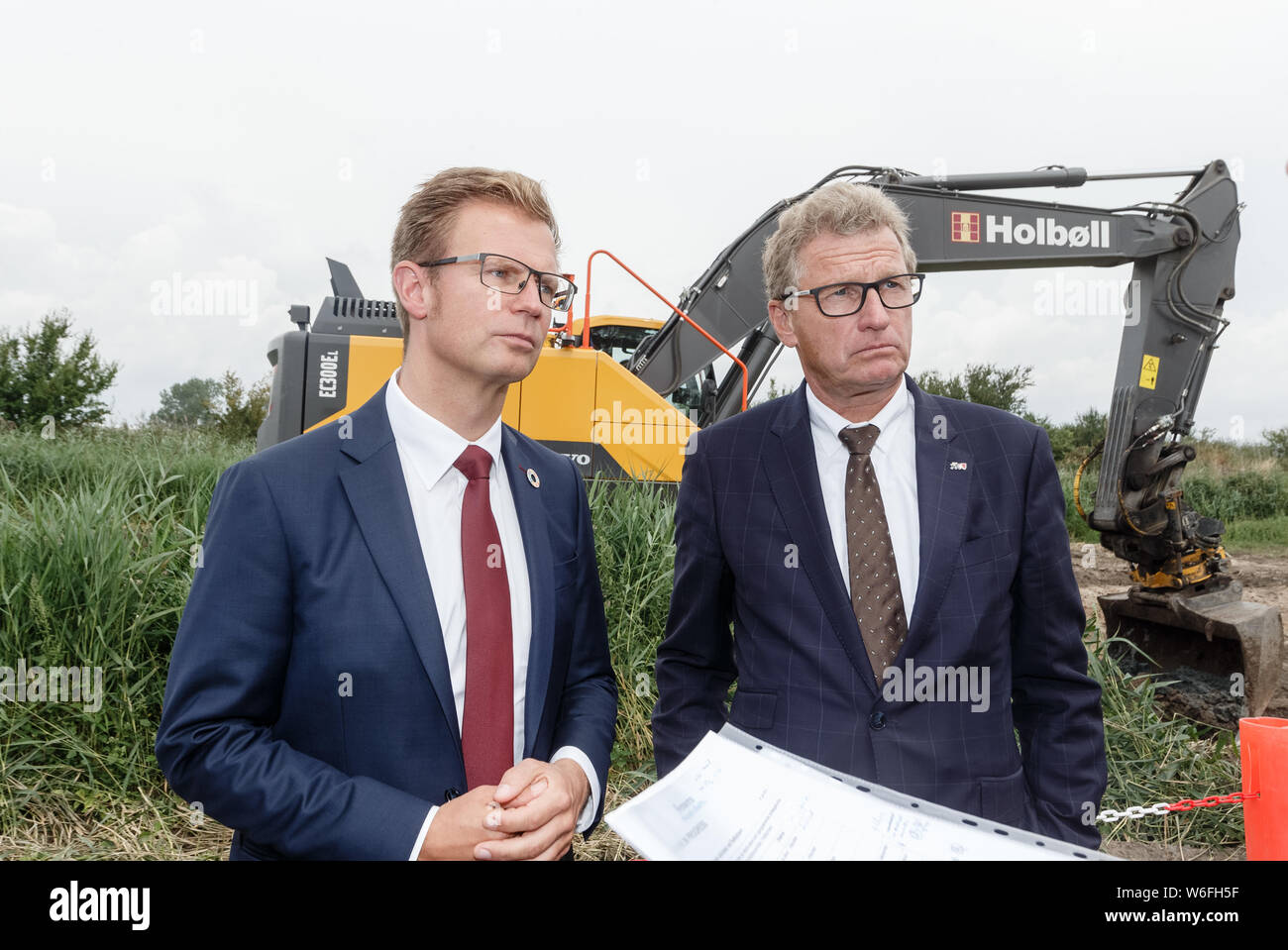 01 August 2019, Denmark, Rødbyhavn: Benny Engelbrecht (l), Minister of Transport of Denmark and Bernd Buchholz (FDP), Minister of Economic Affairs of Schleswig-Holstein, jointly visit the construction site of the planned Fehmarnbelt tunnel. Photo: Markus Scholz/dpa Stock Photo