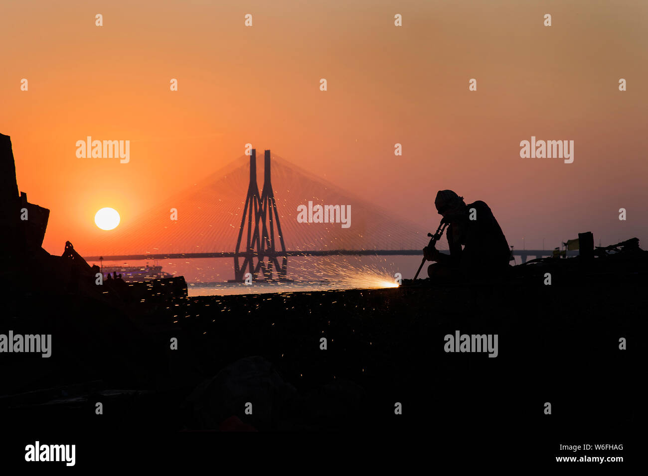 The image of Man working and Worli bandra sealink bridge, at Mumbai, India Stock Photo