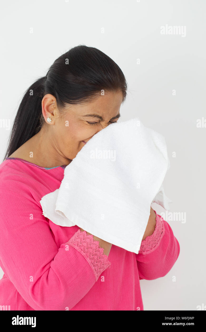 Woman blowing nose with handkerchief Stock Photo Alamy