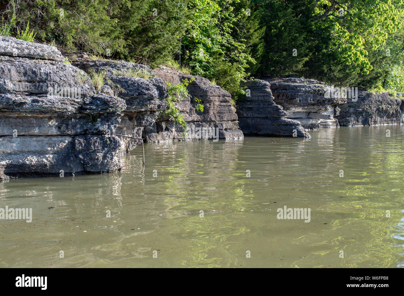 Rock cliffs at lake Eucha in Oklahoma makes a beautiful scenic view and an outstanding spot for limb line fishing. Bokeh. Stock Photo