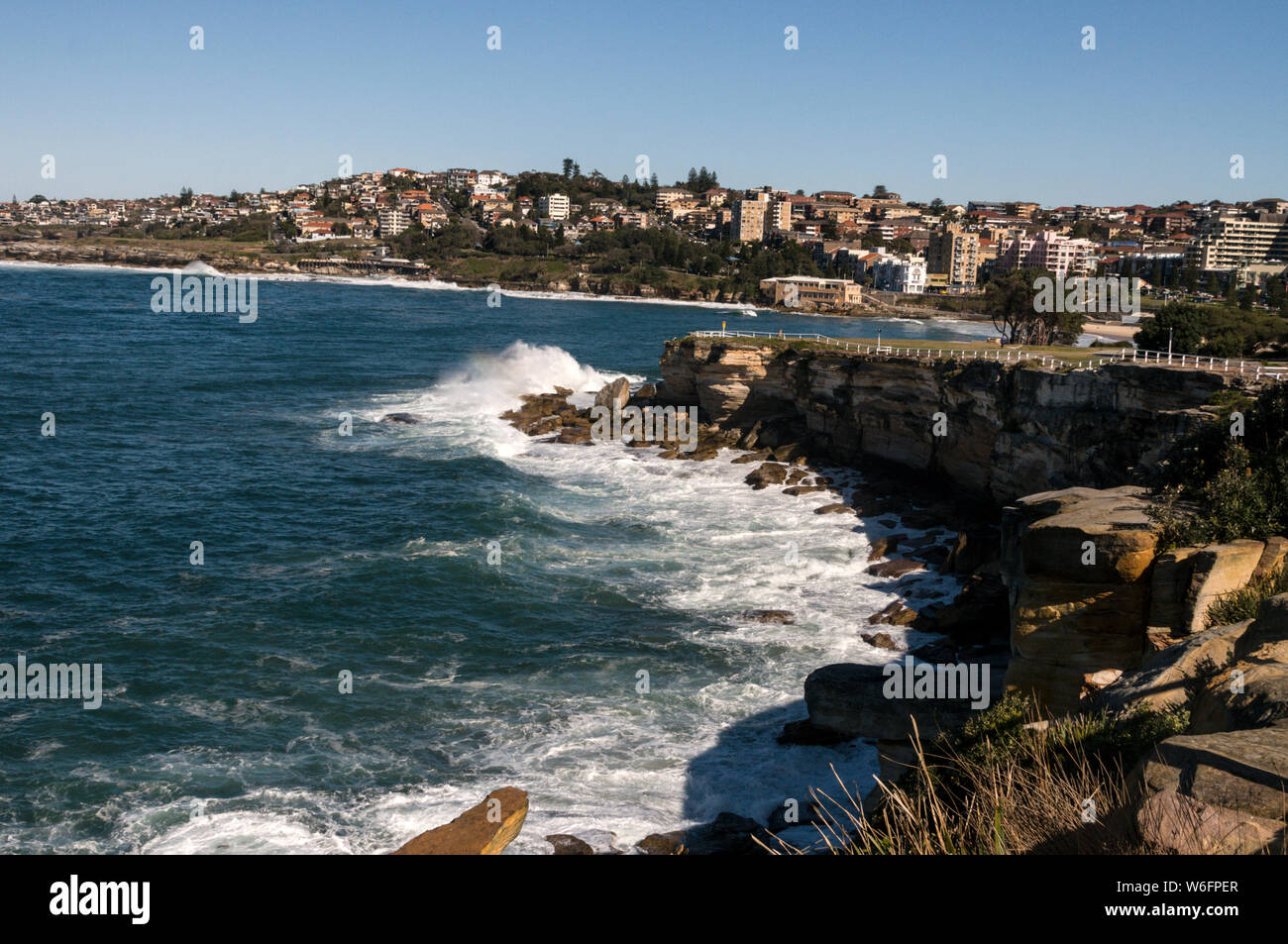 High waves smash onto rocks along the coast at Dolphins Point near Coogee in New South Wales, Australia   Coogee beach  is a wide circular sandy bay, Stock Photo