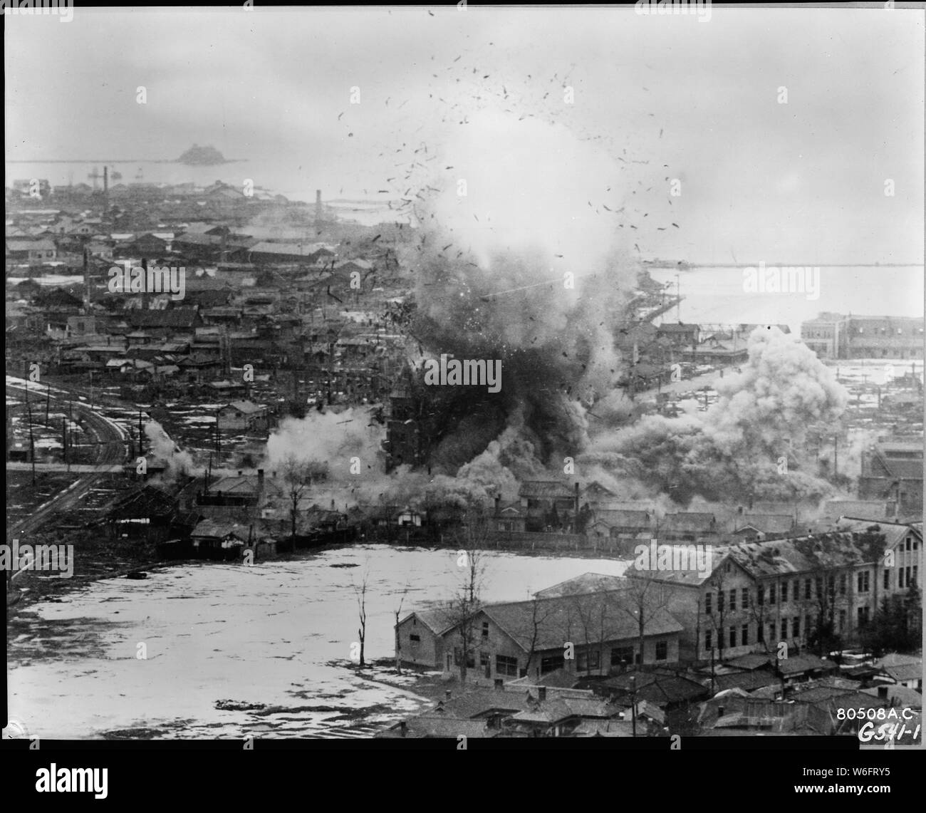 COSTLY VISIT. Immediate explosion from a direct hit made be a B-26 Invader light bomber on a church containing high explosives for the Communists, is shown in this photo the second after the 452nd Light Bomb Wing's plane had dropped its bombs directly on target. Wonsan harbor on the east coast of Korea is shown in the background, while buildings of the military supply area in the foreground are shown damaged in previous strikes. Stock Photo