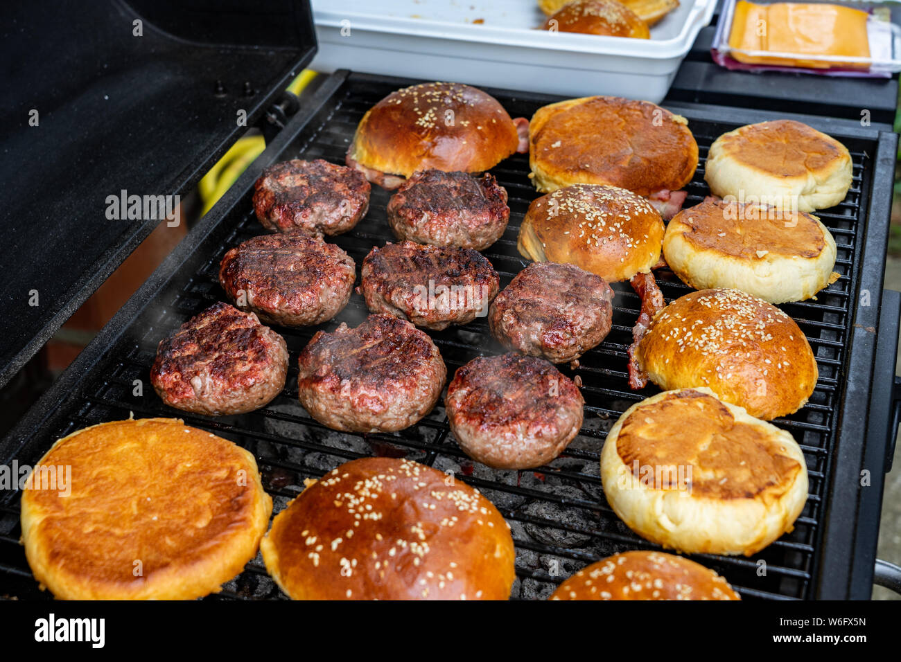 Hamburgers cooking on the grill outdoor Stock Photo