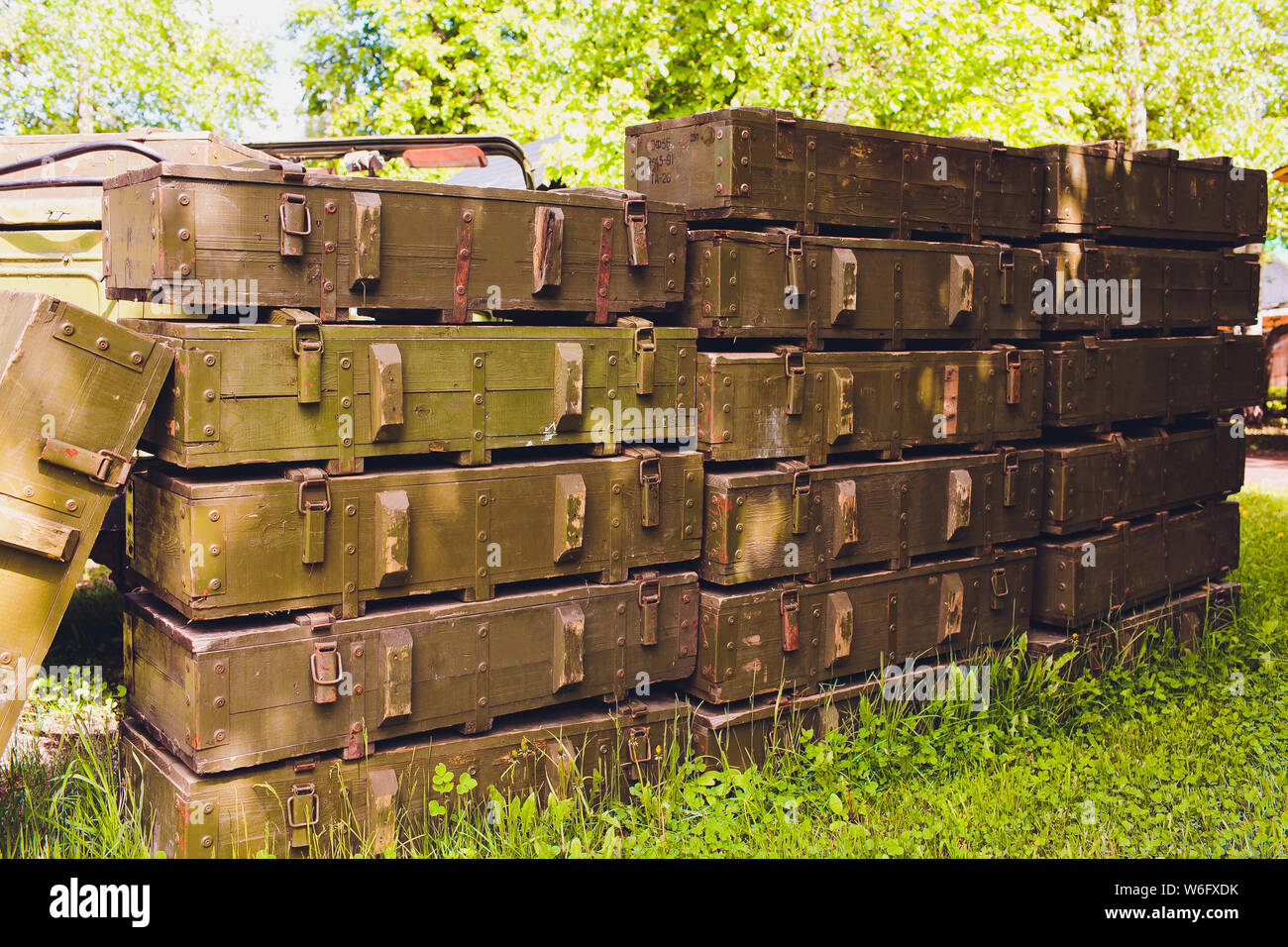 Military green boxes with dangerous explosives, guns and