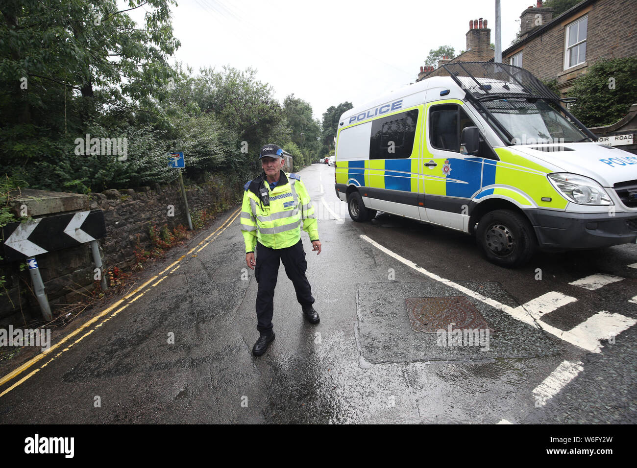 RETRANSMITTING CORRECTING CHESHIRE TO DERBYSHIRE CORRECT CAPTION BELOW A policeman blocks the road leading to Toddbrook Reservoir near the village of Whaley Bridge, Derbyshire, after a wall around it was damaged in heavy rainfall. Stock Photo