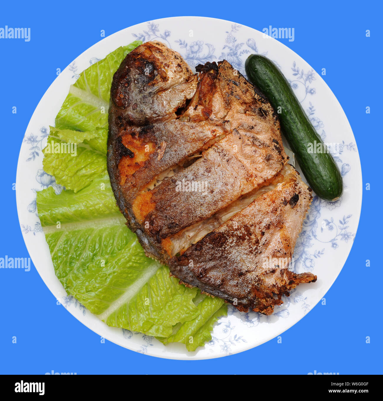 deep fried butter fish dish isolated on purple background Stock Photo