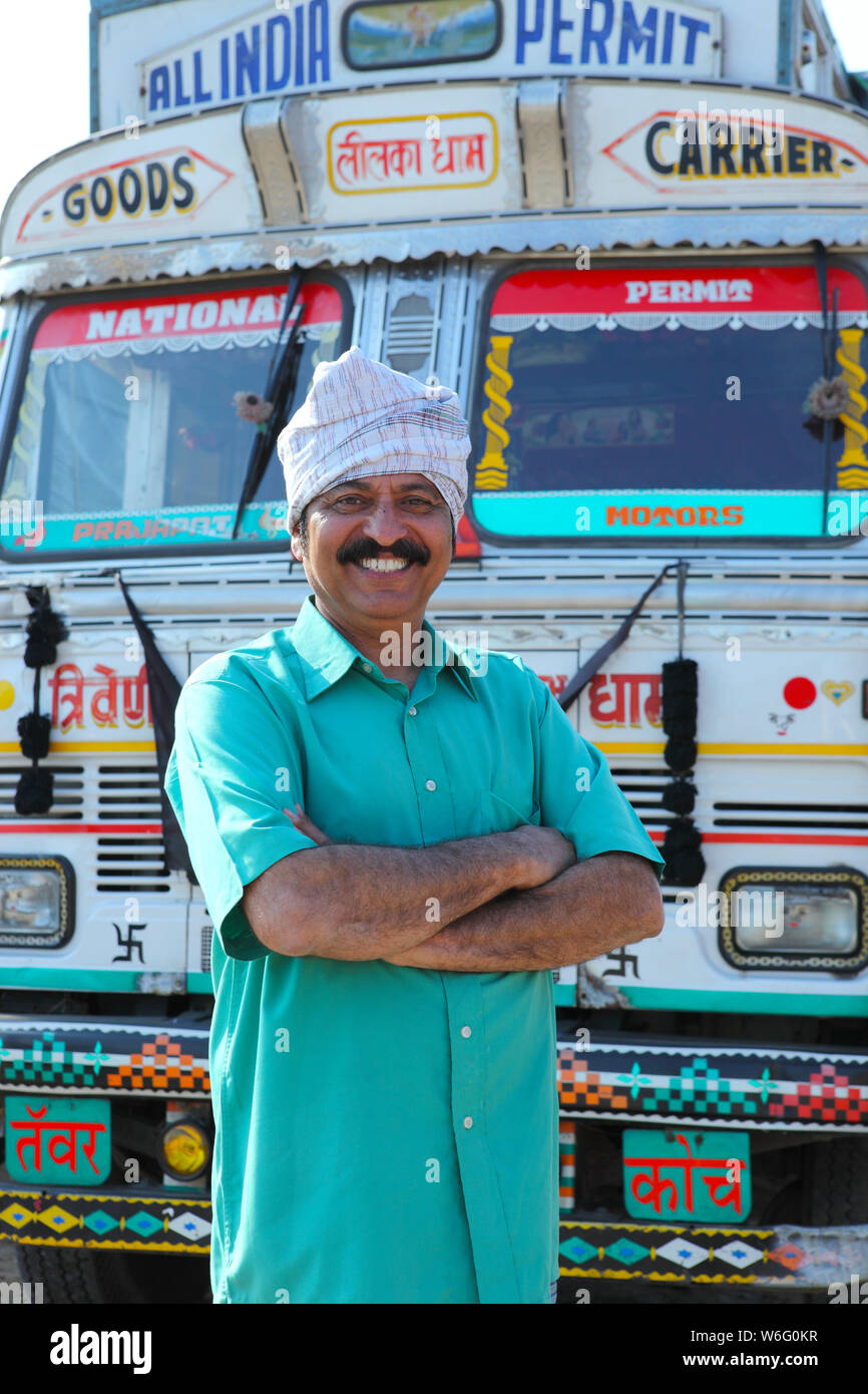 Truck driver standing with his arms crossed Stock Photo Alamy