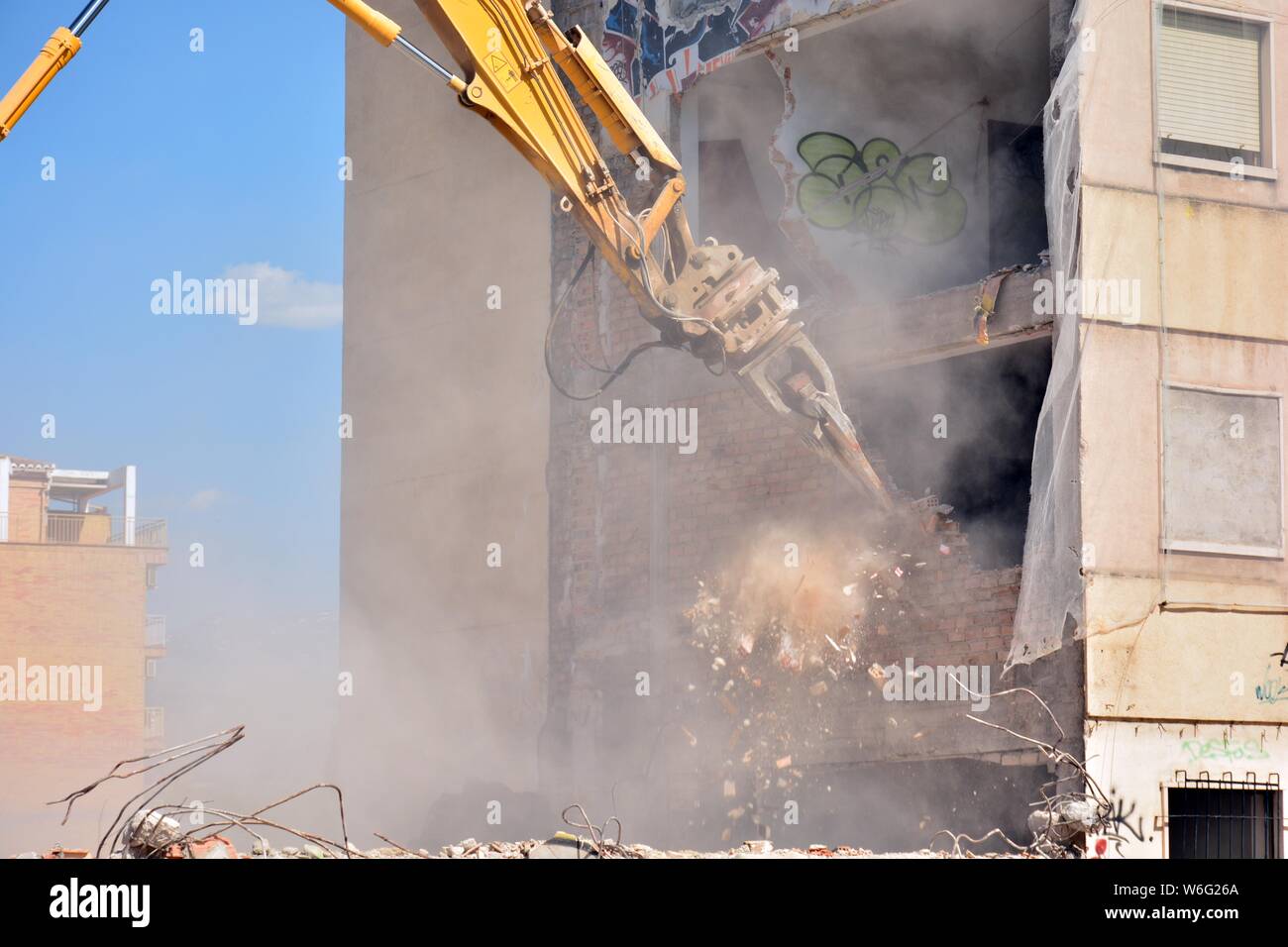 Gran máquina demoliendo un viejo edificio de apartamentos Stock Photo