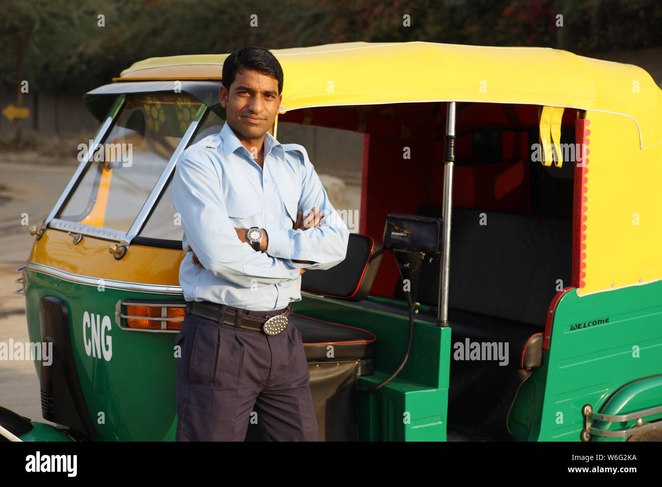 Auto driver standing with his arms crossed Stock Photo Alamy