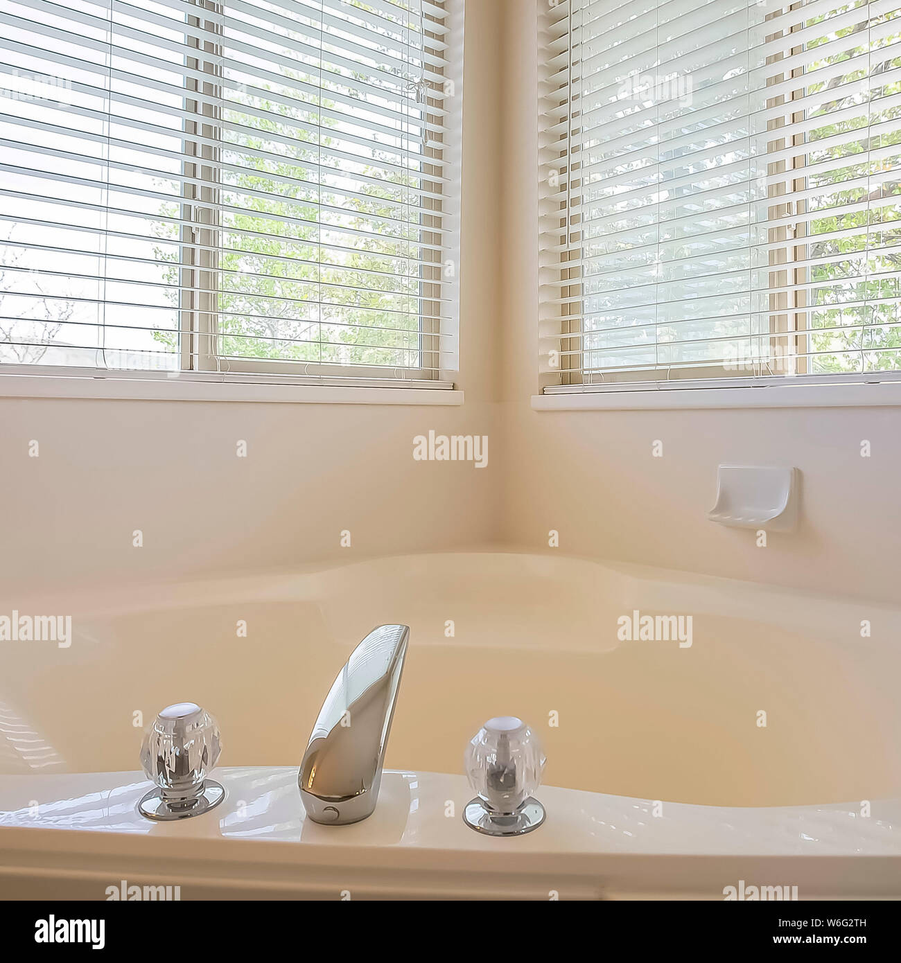Square Gleaming Heart Shaped Built In Bathtub At The Corner Of A Bathroom Stock Photo Alamy