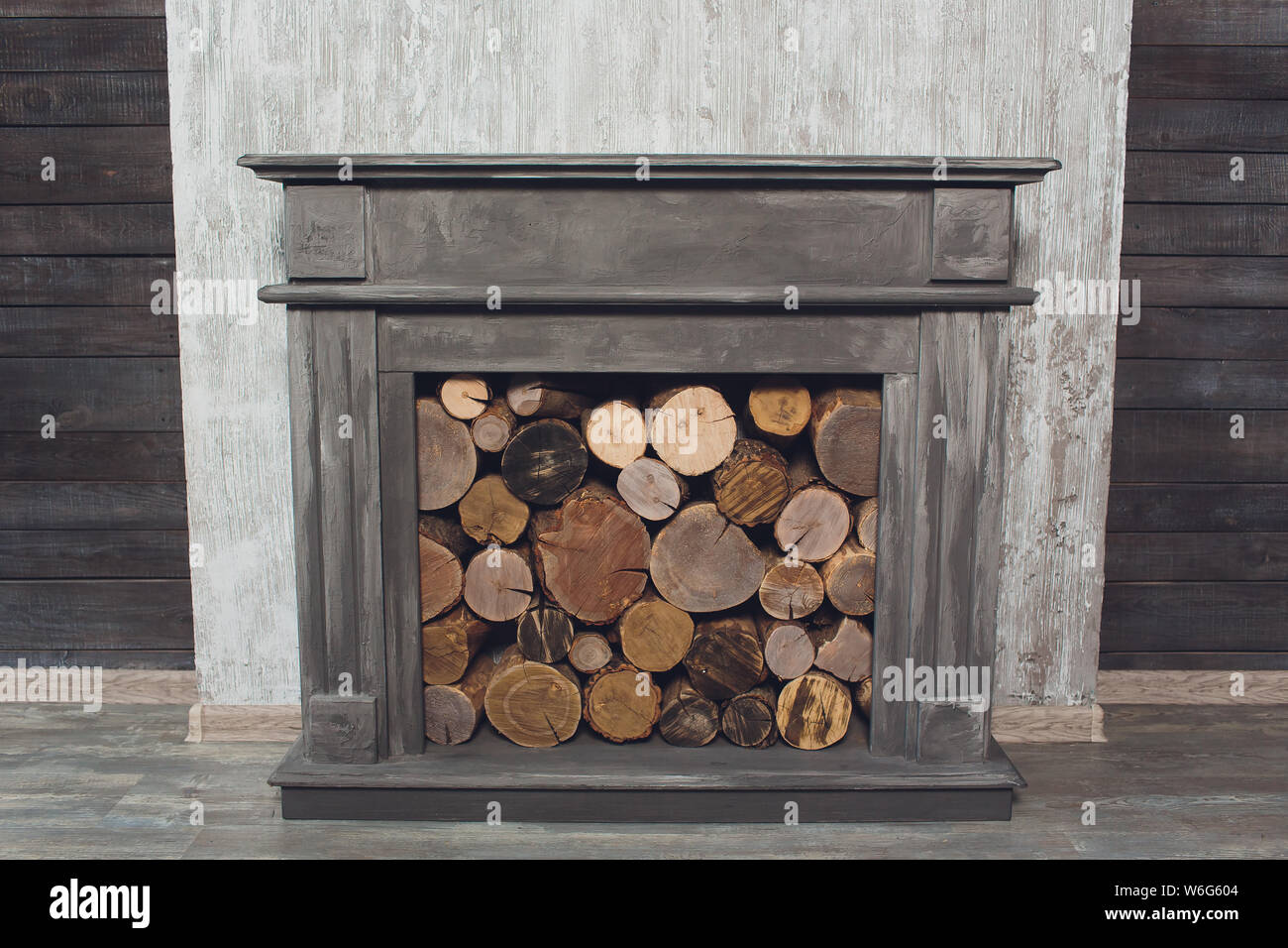 Tradional Wood Burning Stove in a Brick Fireplace. Stock Photo