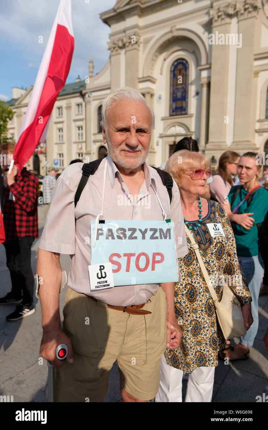 Warsaw Poland - Thursday 1st August - Poles gather at the Warsaw Uprising monument to commemorate the 75th Anniversary of the start of the Warsaw Uprising ( Powstanie Warszawskie ) against the occupying German Army on 1st August 1944 - this mans sign reads Stop Fascism - the Warsaw Uprising resistance fighters of the Home Army ( Armia Krajowa - AK ) struggled on for 63 days against the Nazi forces before capitulation as the advancing Soviet Army waited across the nearby River Vistula. Credit: Steven May/Alamy Live News Stock Photo