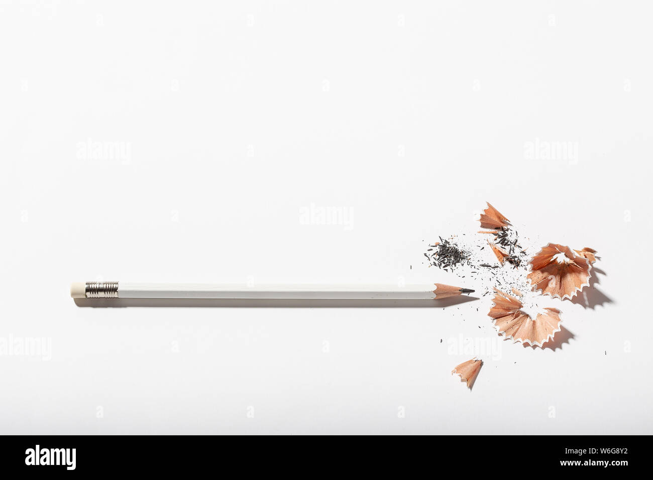 White Pencil with sharpening shavings on white background. Back to school concept. Copy space for text Stock Photo