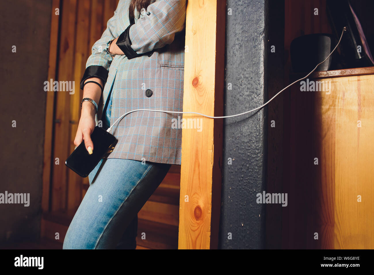 Girl using mobile phone while charging the battery Stock Photo Alamy