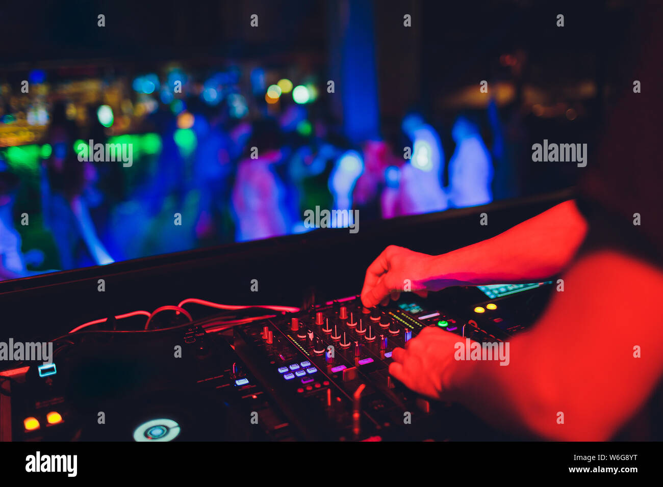 DJ turntable console mixer controlling with two hand in concert