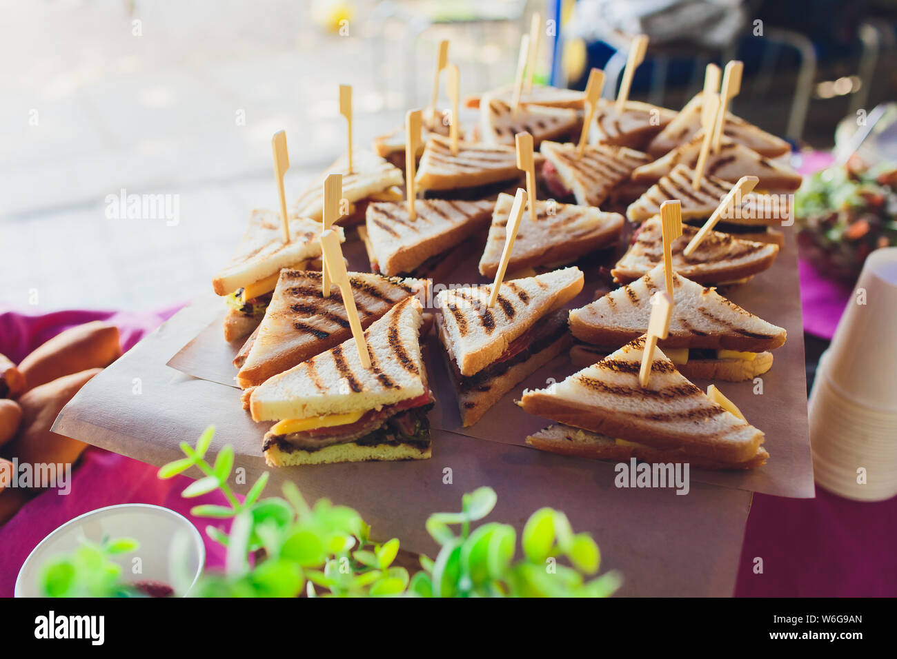 Cut platter of mixed sandwich triangles, on the buffet table. Stock Photo