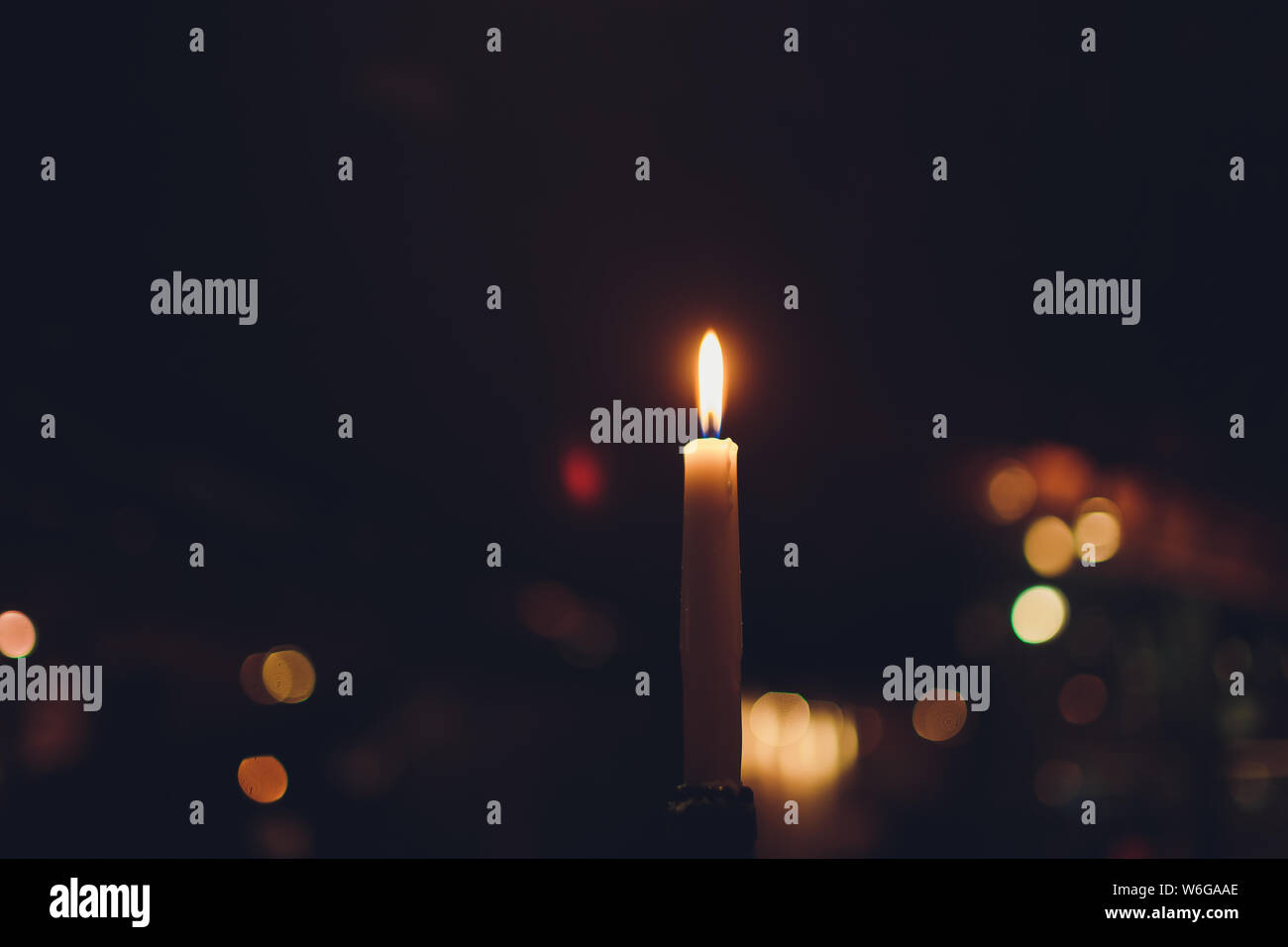 Candles Burning at Night. White Candles Burning in the Dark with focus on  single candle in foreground Stock Photo - Alamy