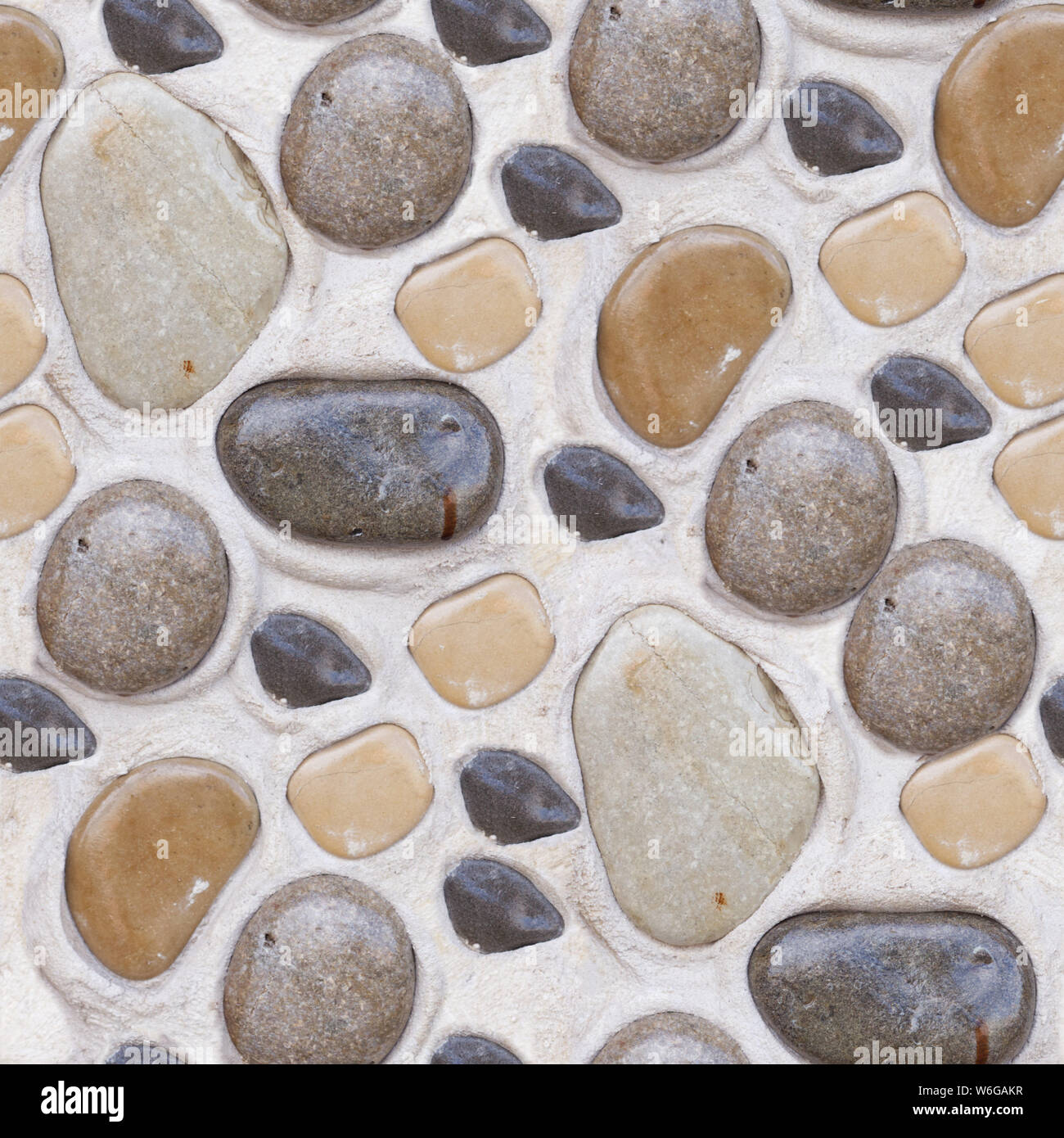 Abstract seamless photo texture of bright rocks in dry cement. Rocks has wet surface. Stock Photo