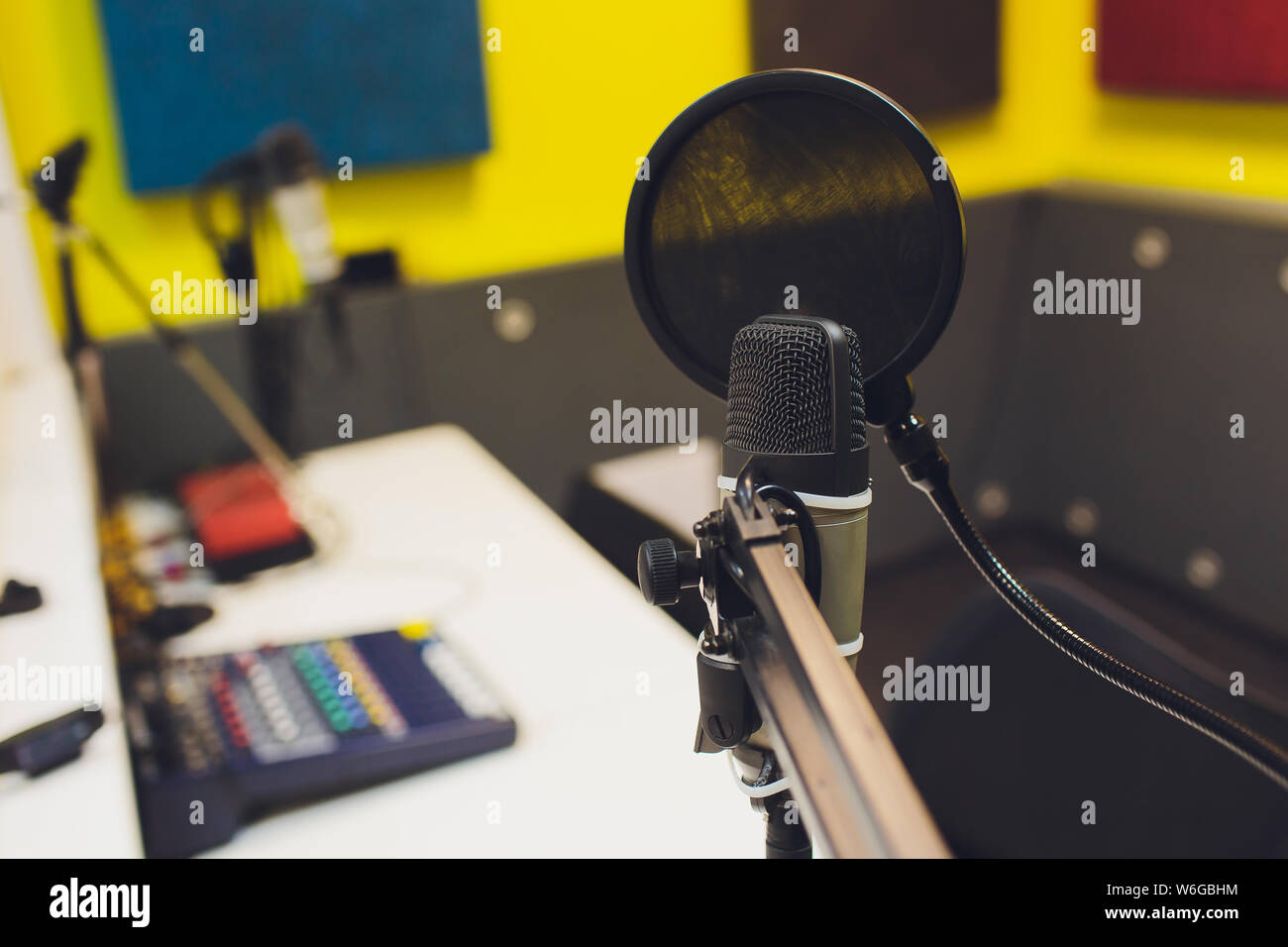 Recording equipment in studio. Studio microphone with headphones and mixer background. Elevated