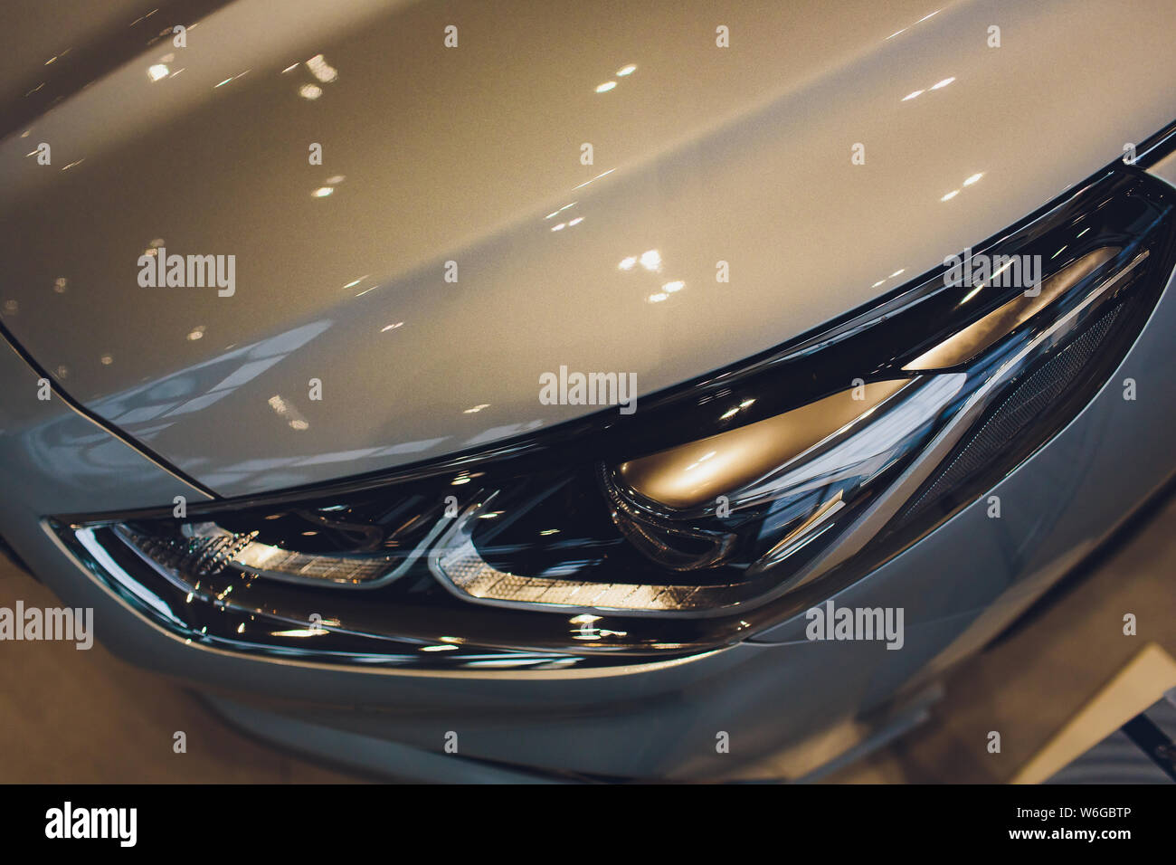 Close up of headlight detail of modern luxury car with projector lens ...