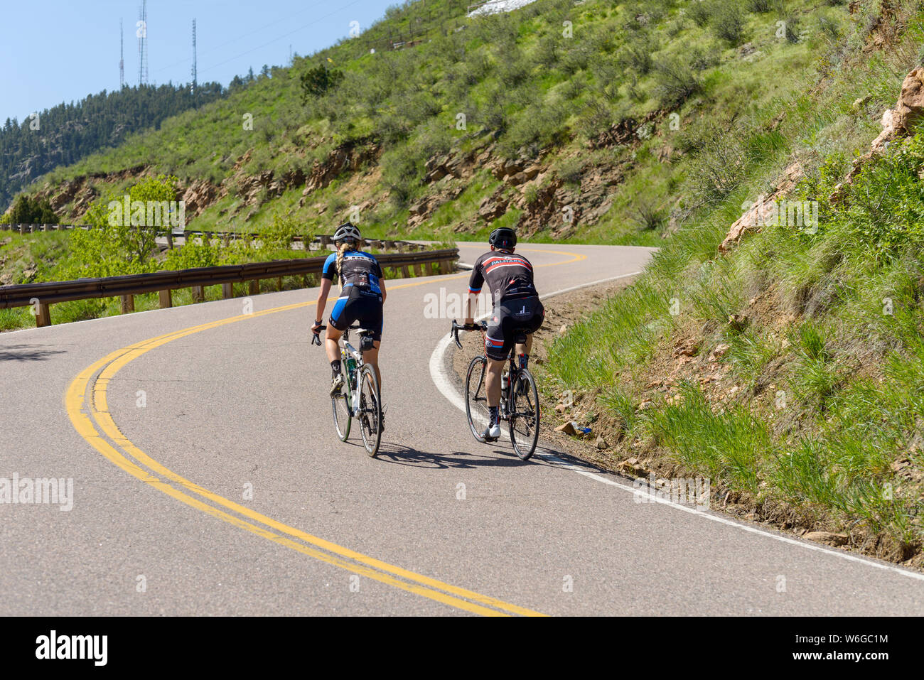 Mountain Biking - Cyclists climbing up a steep and winding mountain road at Lookout Mountain near city of Golden, Colorado, USA. Stock Photo
