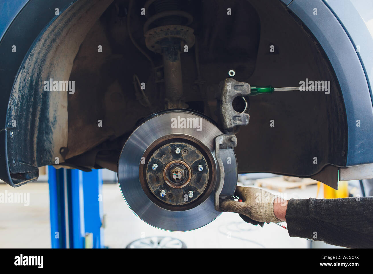Car raised on car lift in autoservice Stock Photo - Alamy