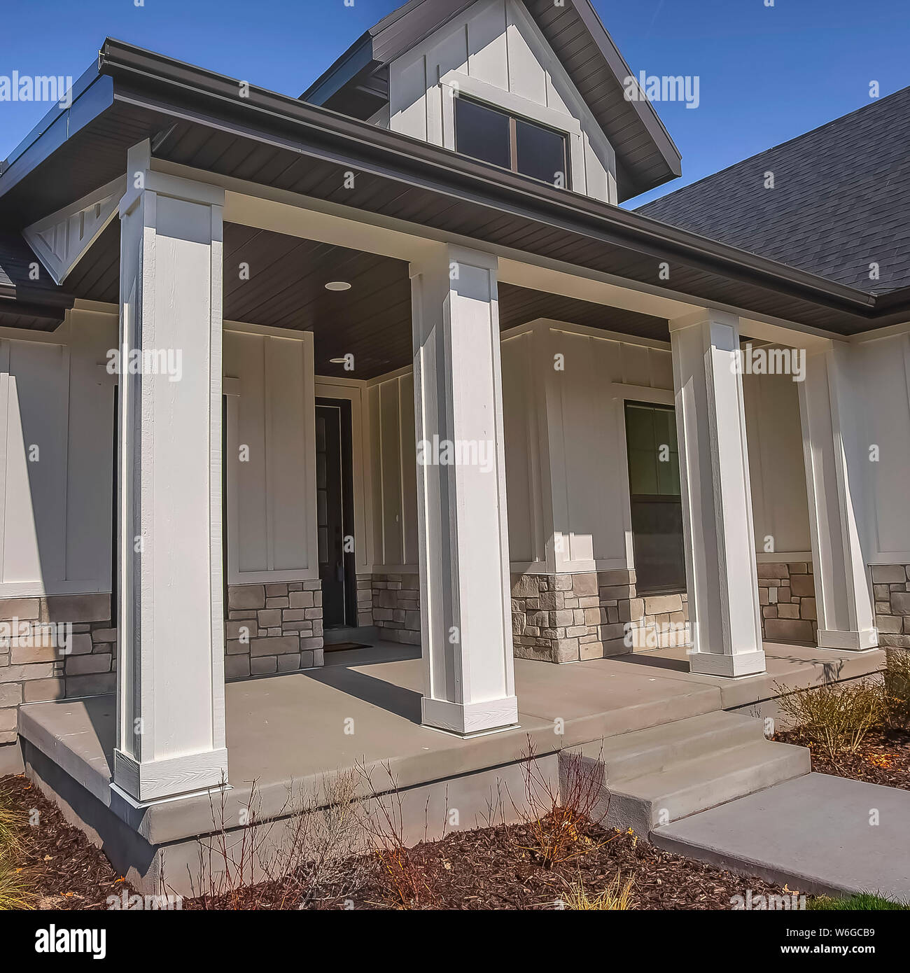 Square Pathway and stairs leading to the porch with pillars at the