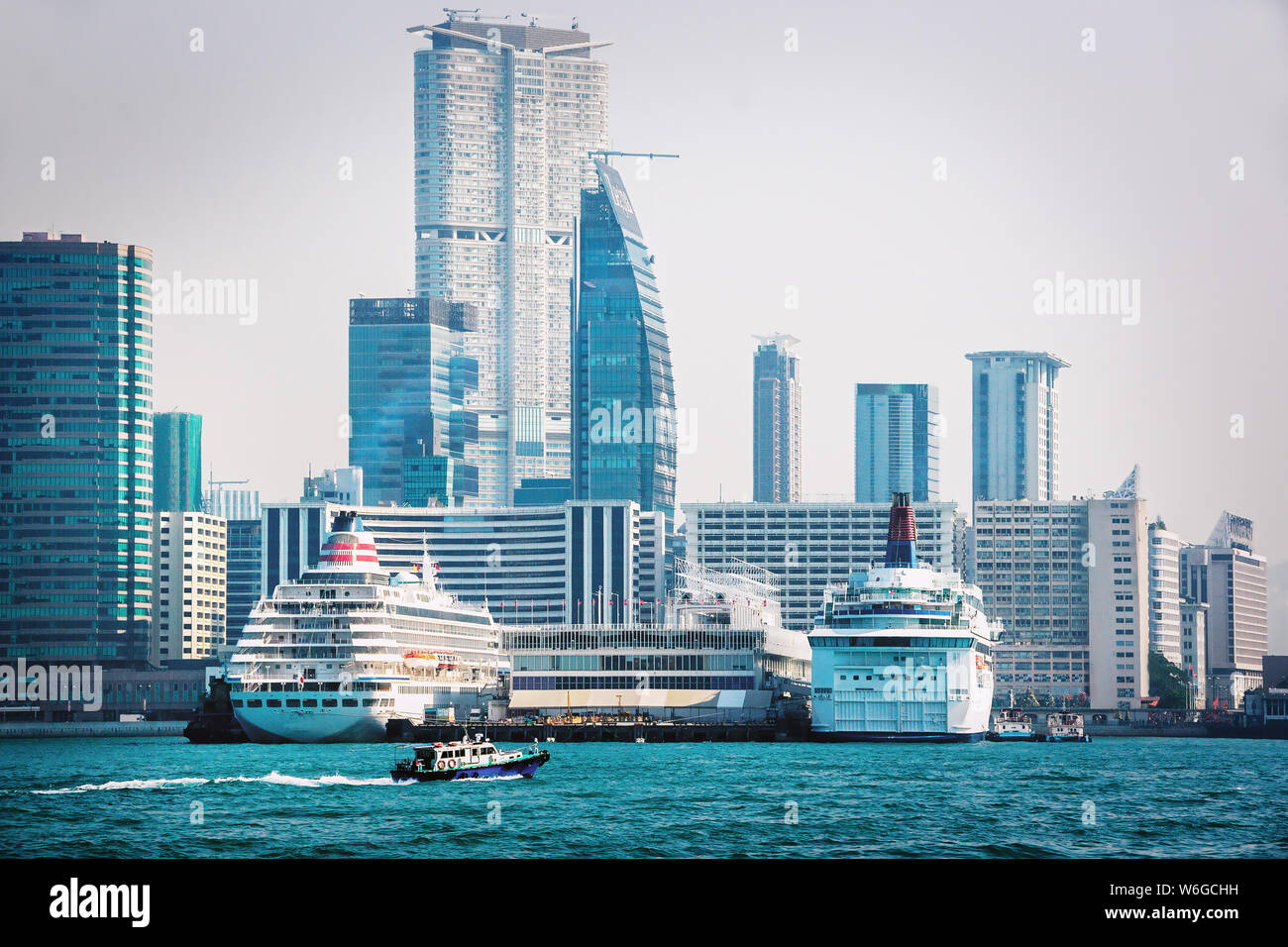 Modern urban skyline of Hong Kong. Modern cruise liners and passenger ferry with skyscrapers of Hong Kong in the background. Cityscape of Hong Kong Stock Photo