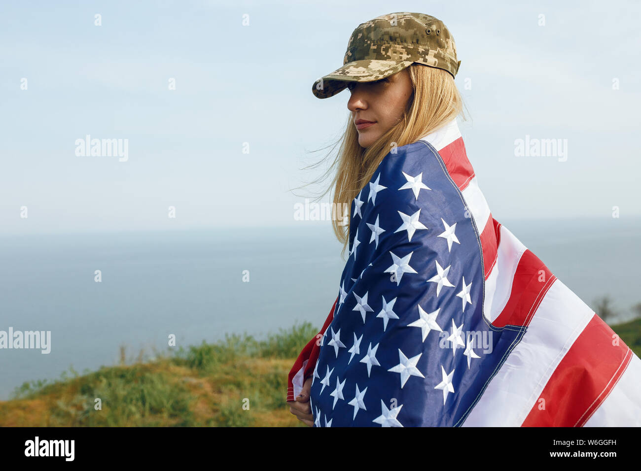 civilian woman in her husband's military cap. A widow with a flag of