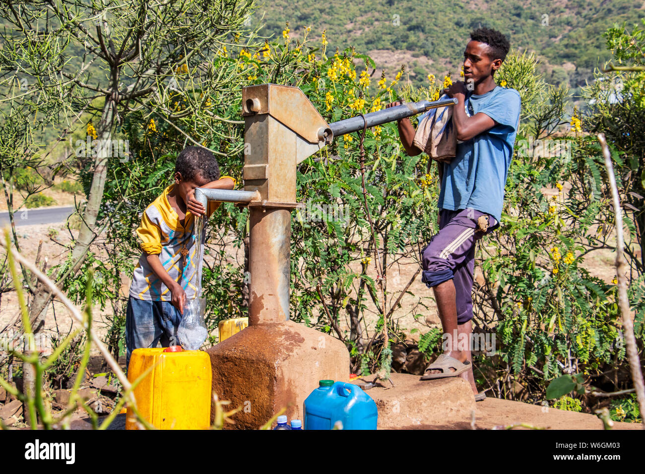 Ethiopian man pumping water; Addis Zemen, Amhara Region, Ethiopia Stock