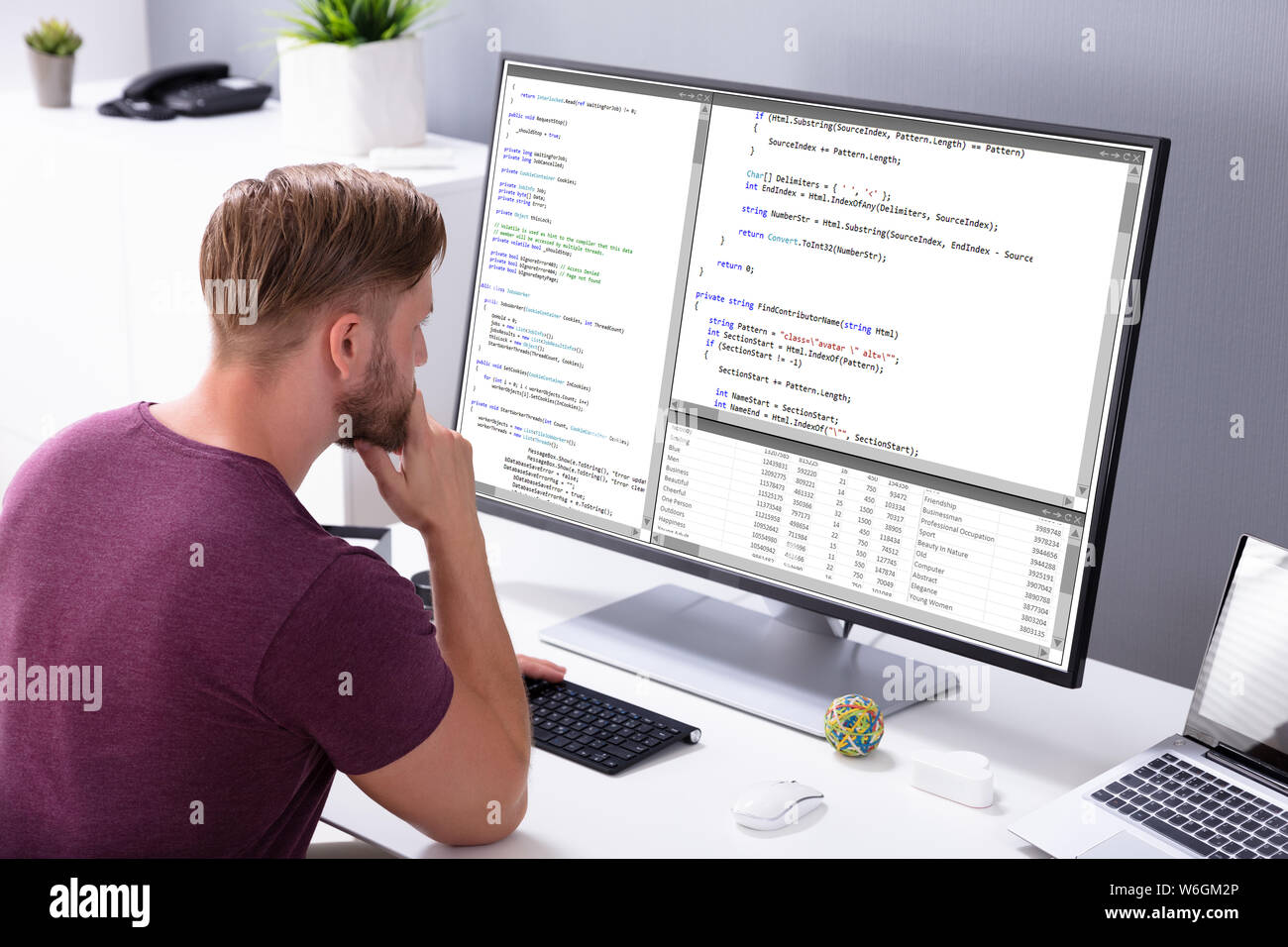 Man Programming Code On Computer In Office Stock Photo