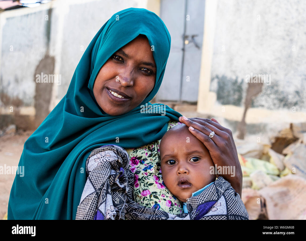 Ethiopian woman holding a boy in Harar Jugol, the Fortified Historic Town; Harar, Harari Region, Ethiopia Stock Photo