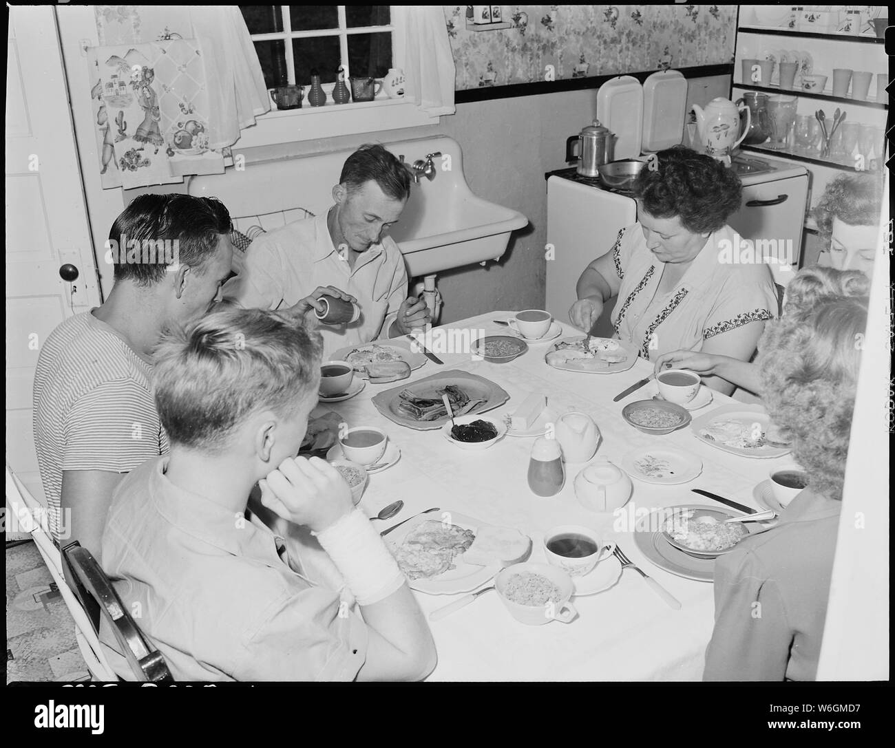Family of Harry Fain, coal loader, at breakfast. When Mr. Fain works on night shift he has breakfast with the family; otherwise he and Mrs. Fain eat breakfast together at 5:15 A.M. Inland Steel Company, Wheelwright #1 & 2 Mines, Wheelwright, Floyd County, Kentucky. Stock Photo