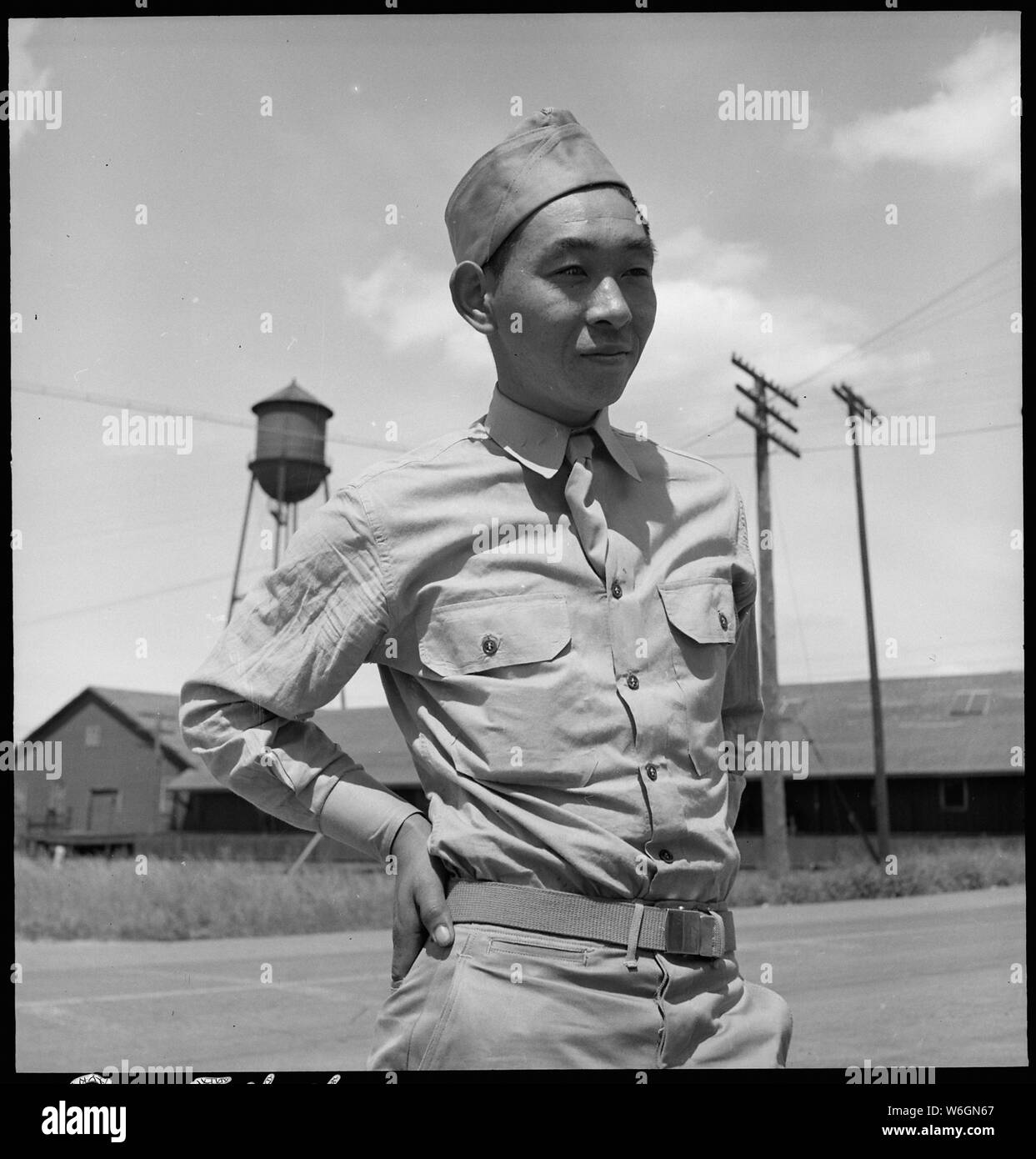Florin, California. This American soldier of Japanese ancestry is shown at the railroad station of a . . .; Scope and content:  The full caption for this photograph reads: Florin, California. This American soldier of Japanese ancestry is shown at the railroad station of a small town in an agricultural community. He and nine other service men of Japanese ancestry received furloughs to enable them to come home to assist their families get ready for evacuation from their west coast homes. He is an older son, which, in the traditional Japanese family structure, means that much responsibility for t Stock Photo