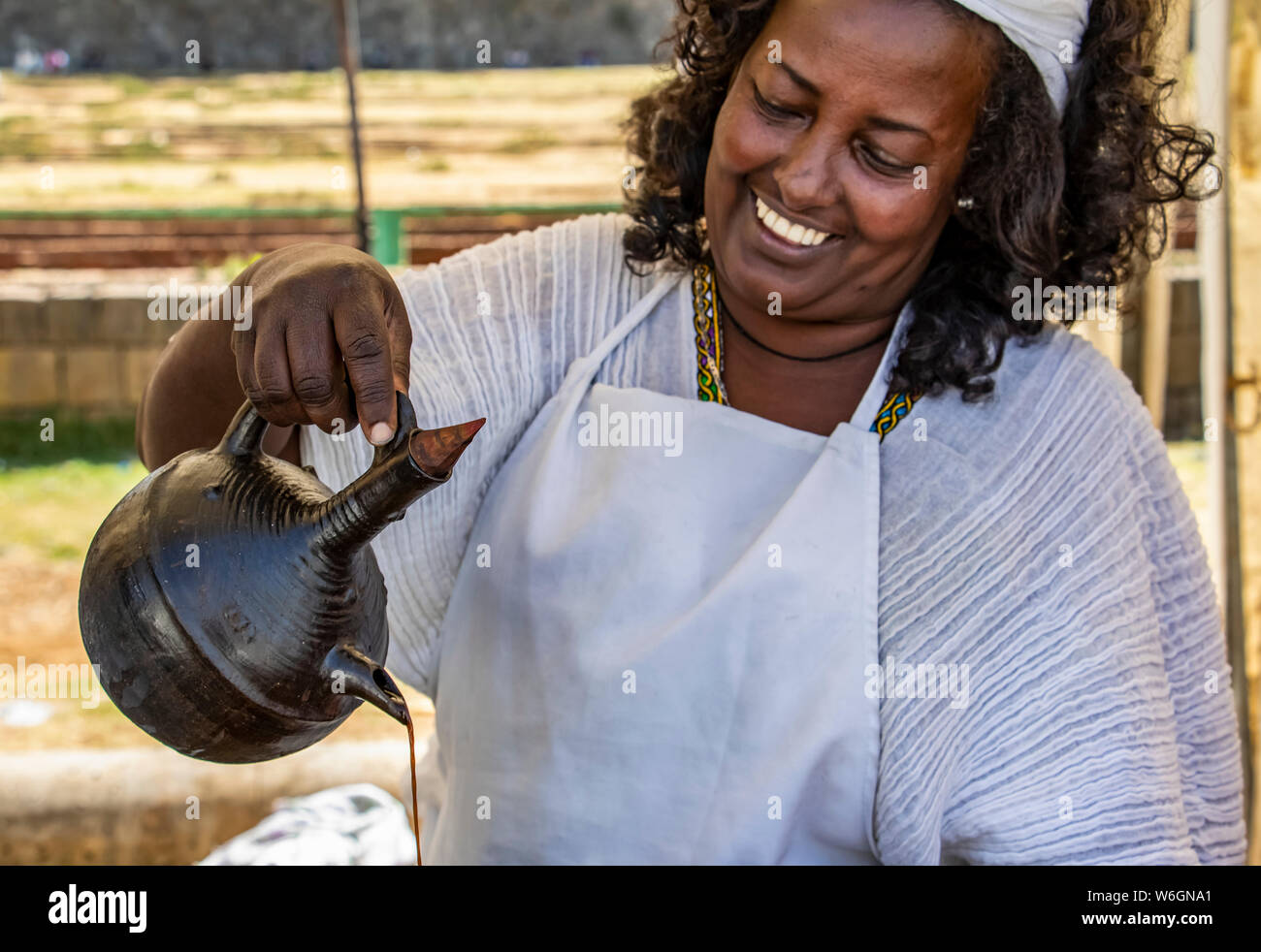 Woman serving coffee in jebena buna, a traditional Ethiopian coffee ceremony; Addis Ababa, Addis Ababa, Ethiopia Stock Photo