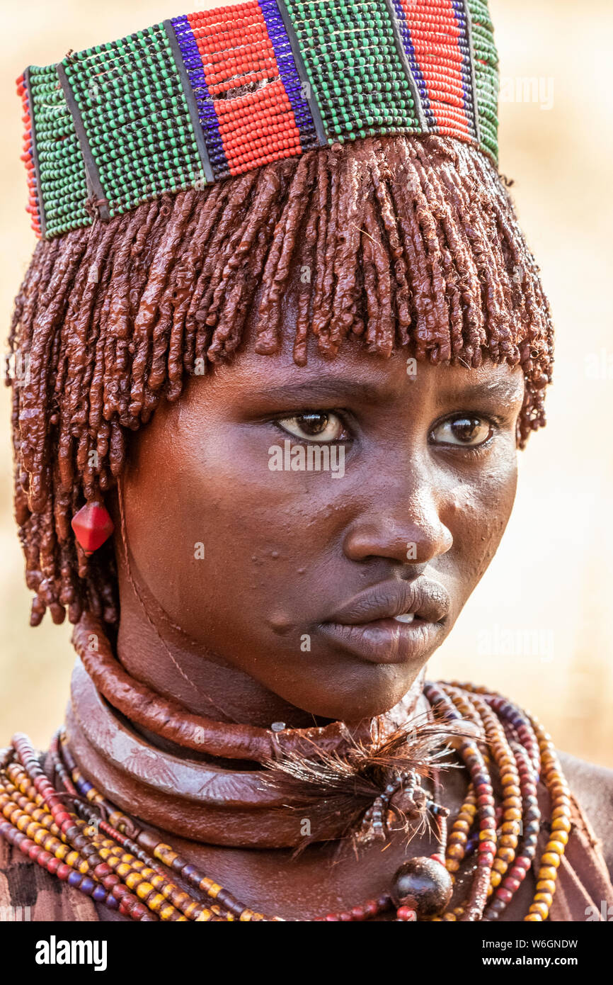 Hamer woman at a bull jumping ceremony, which initiates a boy into manhood, in the village of Asile; Omo Valley, Ethiopia Stock Photo