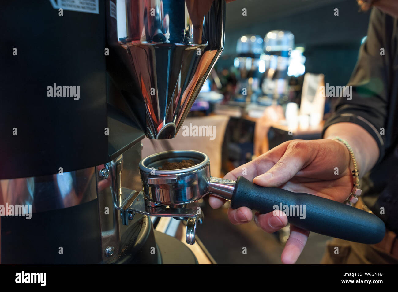Grinding and dosing of coffee for the professional espresso machine Stock Photo Alamy