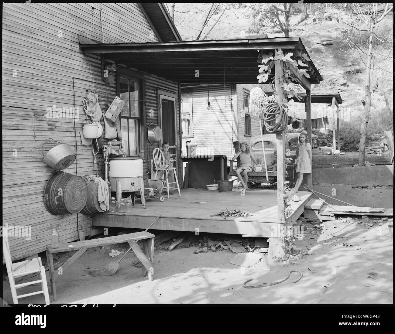 Front porch of home of Virgil Price, miner. They have lived here 12 years. Have 4 children, 2 beds, pay rent $10 per month, electricity is extra, running water is outside on porch. Black Mountain Corporation, 30-31 Mines, Kenvir, Harlan County, Kentucky. Stock Photo