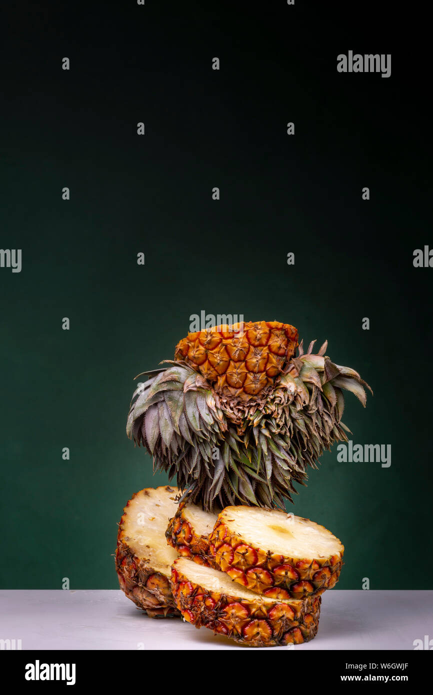 Entire pineapple sliced in several parts forming a pile with yellow ...