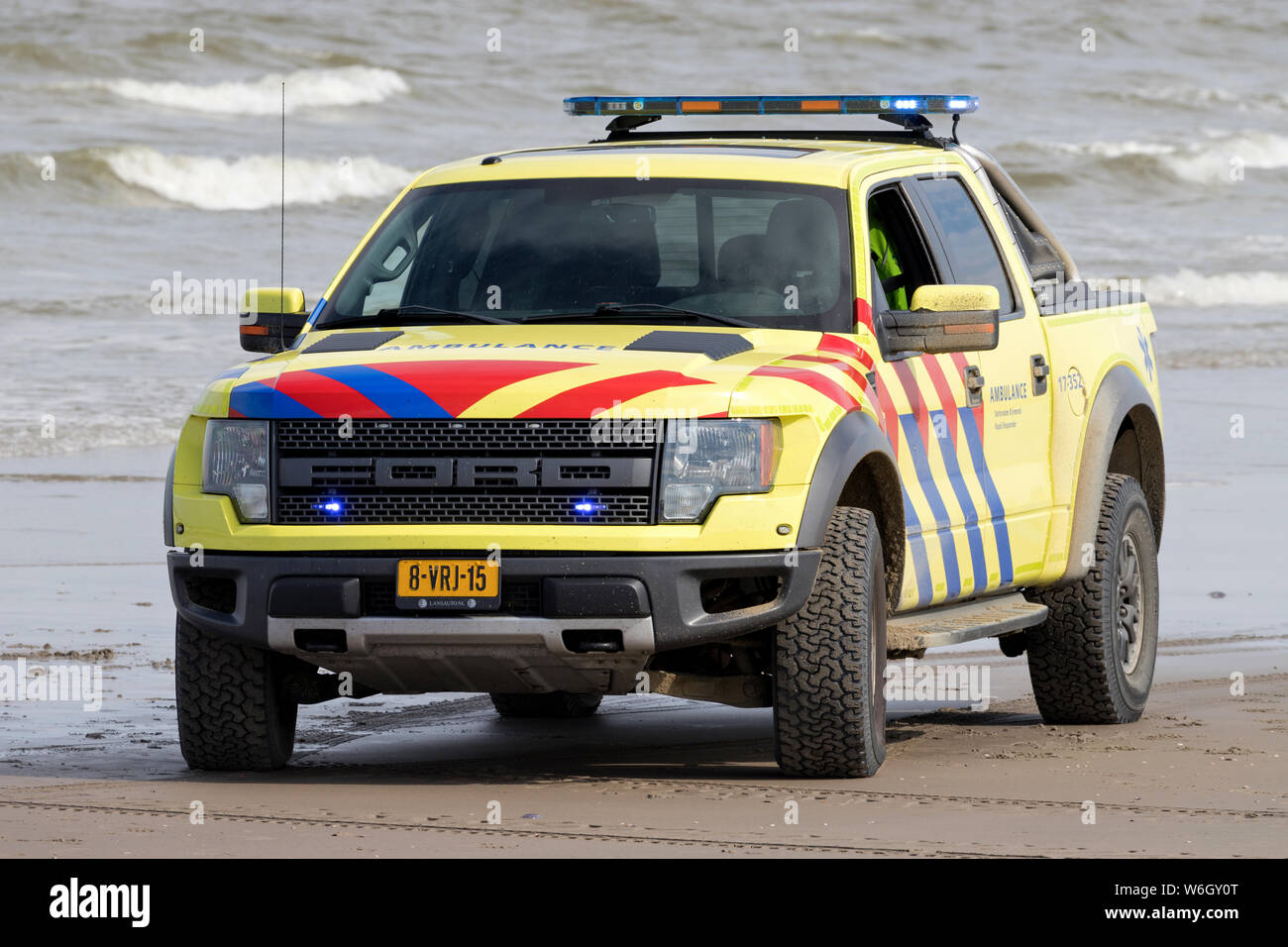 Dutch ambulance Ford F-150 with active blue emergency lighting on the beach Stock Photo