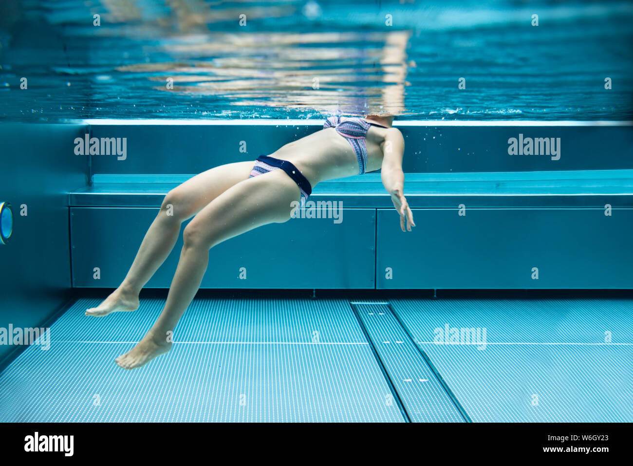 Below Water Photo Of Woman Swimming In Pool In Stock Photo