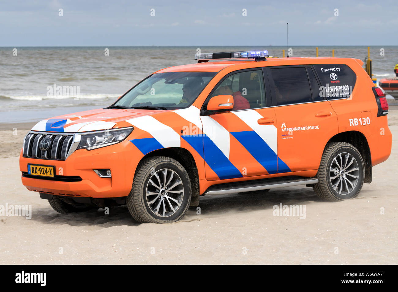 Dutch lifeguard Toyota Land Cruiser with active blue emergency lighting on the beach Stock Photo