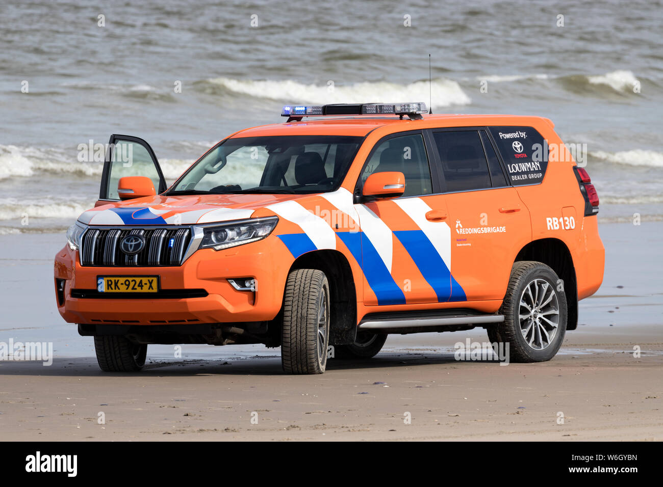 Dutch lifeguard Toyota Land Cruiser with active blue emergency lighting on the beach Stock Photo