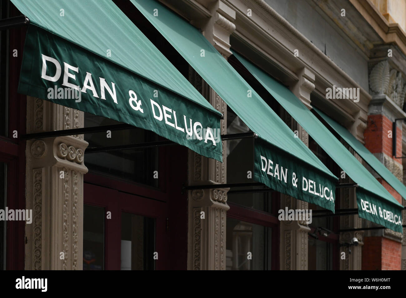 Pedestrians pass in front of a Dean & DeLuca store in the Soho neighborhood of New York. Stock Photo